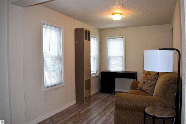 sitting room with dark hardwood / wood-style flooring and a textured ceiling