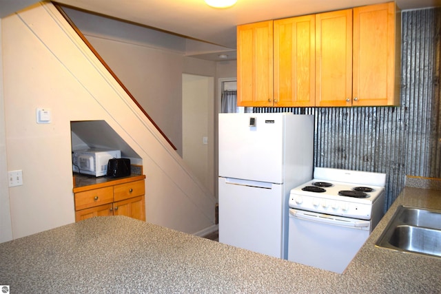 kitchen with sink and white appliances