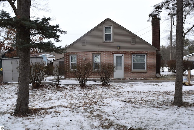 view of snow covered back of property