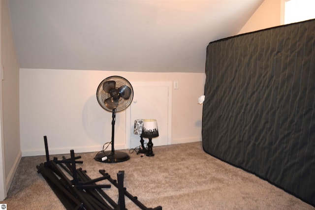 exercise area with lofted ceiling and carpet