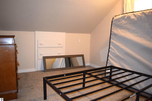 carpeted bedroom featuring lofted ceiling