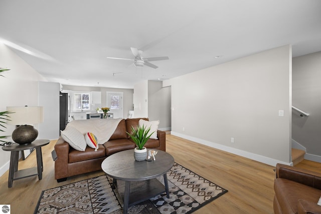 living room featuring ceiling fan and light wood-type flooring