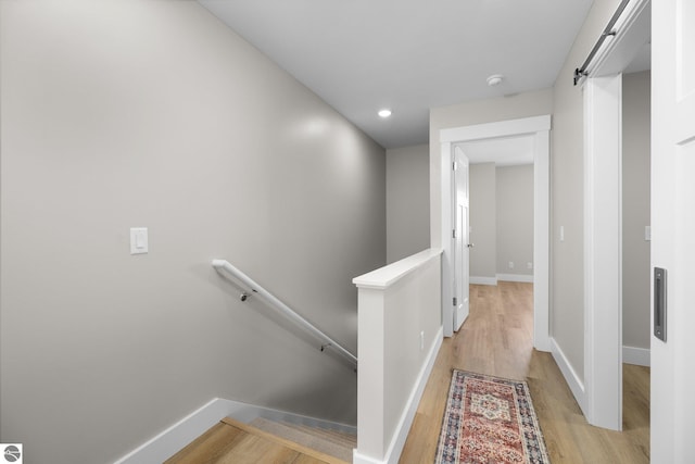 corridor with light hardwood / wood-style flooring