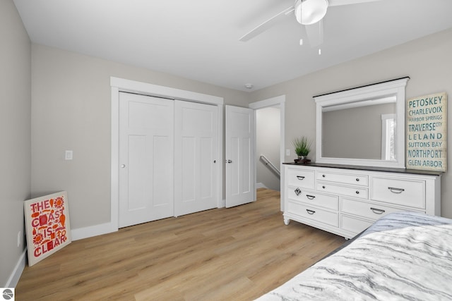 bedroom featuring light hardwood / wood-style flooring, a closet, and ceiling fan