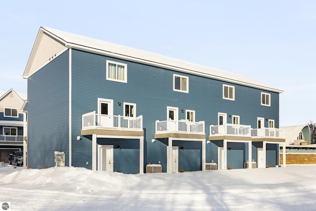 view of snow covered rear of property