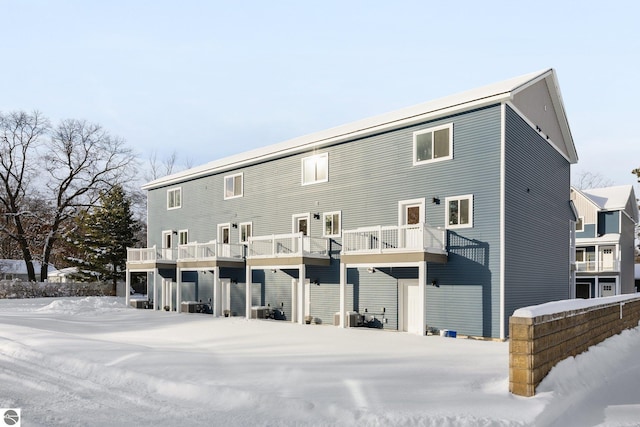 view of snow covered rear of property