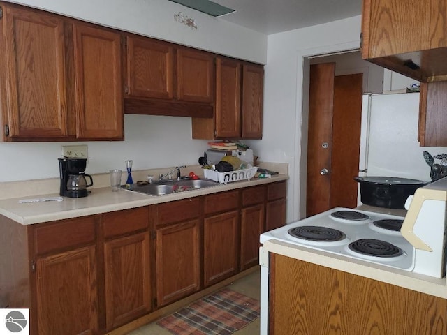 kitchen featuring white refrigerator and sink