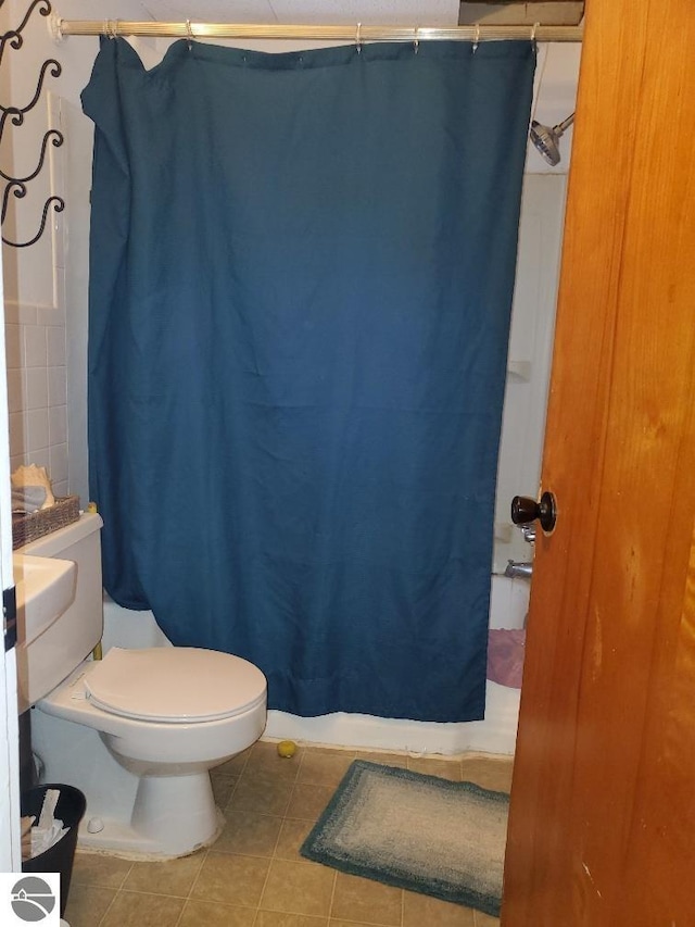 bathroom with tile patterned flooring and toilet