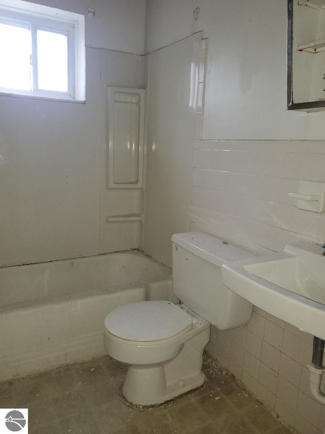 bathroom with shower / bath combination and toilet