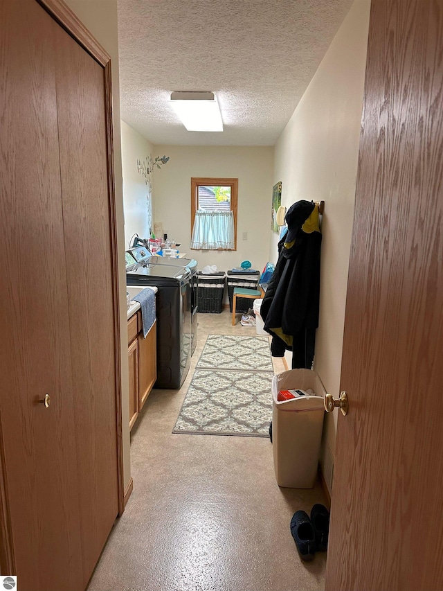 bathroom featuring vanity, washer and dryer, and a textured ceiling