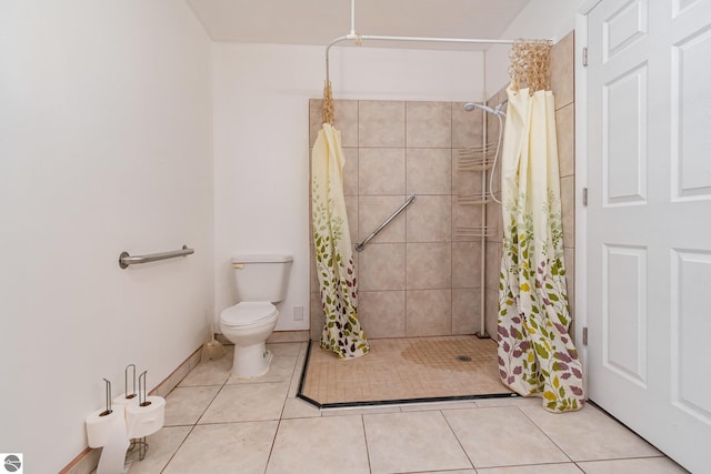 bathroom featuring curtained shower, tile patterned floors, and toilet