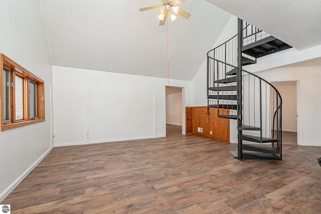 unfurnished living room featuring high vaulted ceiling, dark hardwood / wood-style floors, and ceiling fan