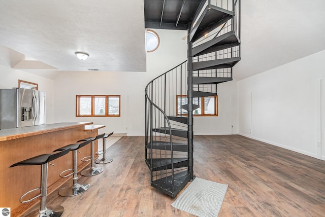 stairway with hardwood / wood-style floors