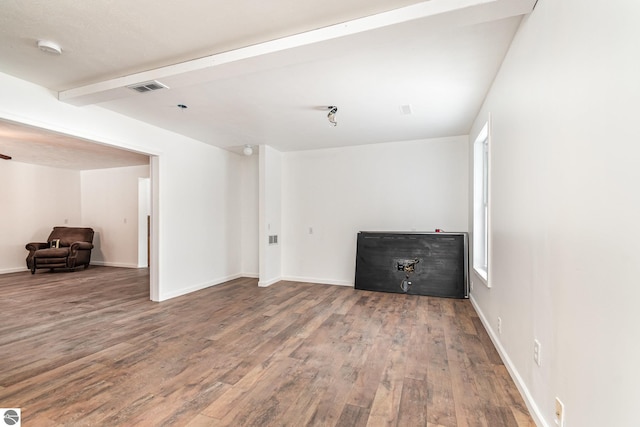 interior space featuring beamed ceiling and hardwood / wood-style flooring