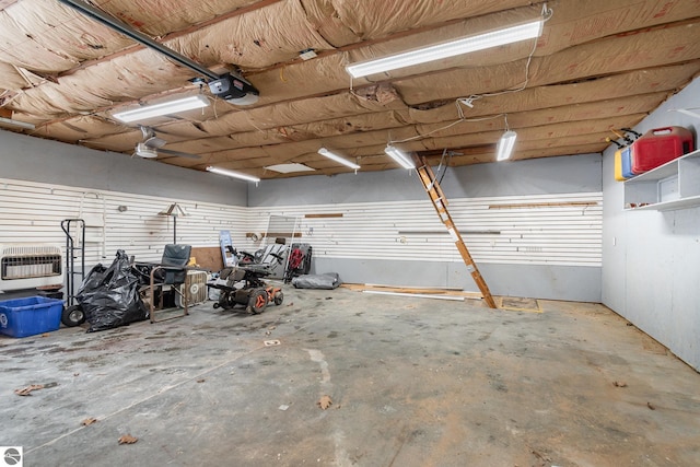 garage with a garage door opener and heating unit