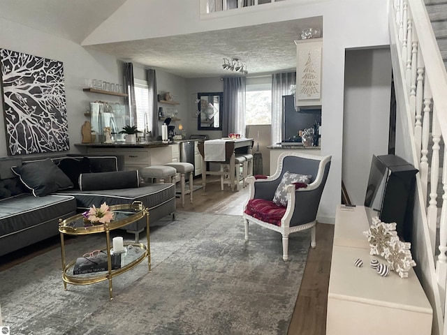 living room featuring a healthy amount of sunlight, hardwood / wood-style floors, and a textured ceiling