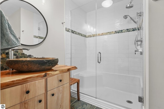 bathroom with vanity and a shower with shower door