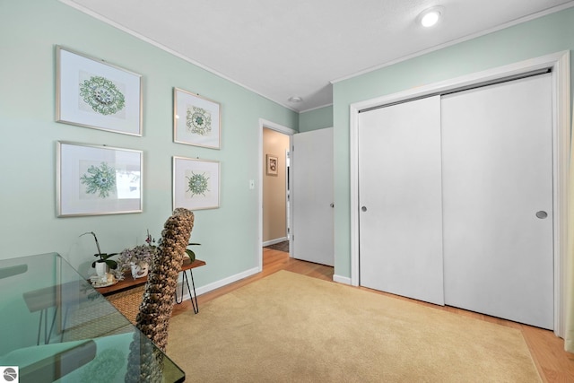 home office with ornamental molding and light hardwood / wood-style flooring