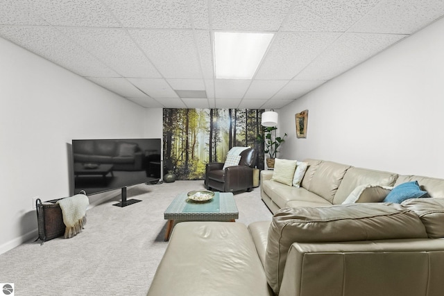 carpeted living room featuring a paneled ceiling