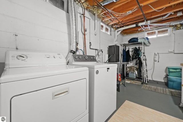 clothes washing area with separate washer and dryer