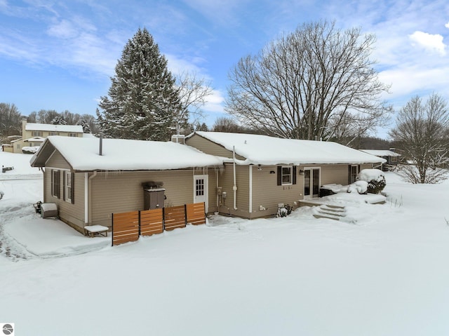 view of snow covered back of property