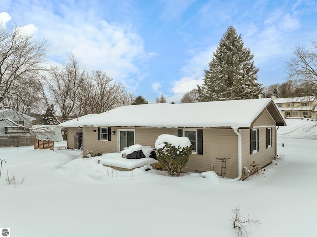 view of snow covered back of property