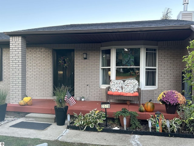 view of exterior entry with a porch