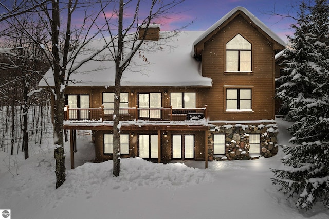 snow covered property featuring a deck