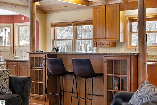 kitchen with light stone countertops and plenty of natural light