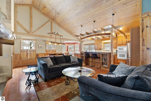 living room with wood ceiling, a healthy amount of sunlight, and wood-type flooring