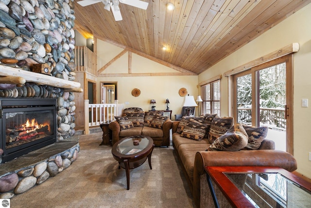 living room with wood ceiling, ceiling fan, high vaulted ceiling, carpet floors, and a stone fireplace