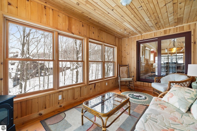 interior space with wooden ceiling, hardwood / wood-style floors, and wood walls