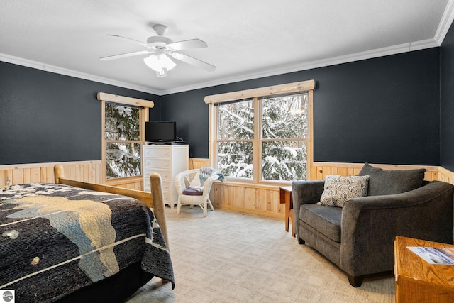 carpeted bedroom featuring crown molding and ceiling fan