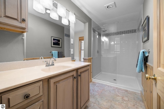 bathroom featuring vanity and a tile shower