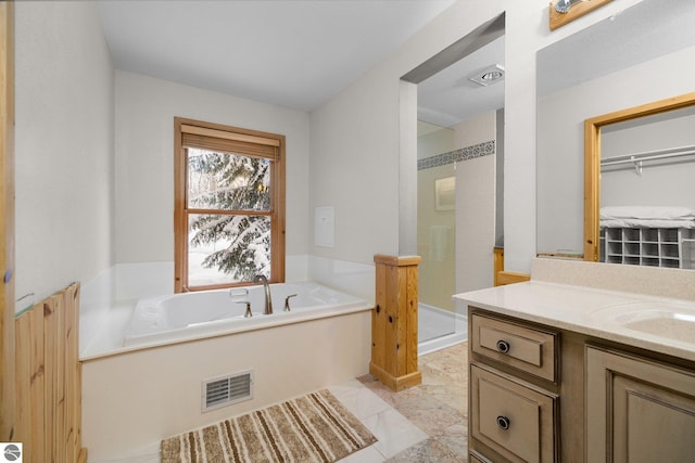 bathroom with shower with separate bathtub and vanity