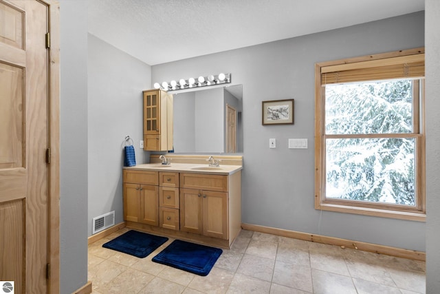 bathroom featuring tile patterned floors and vanity