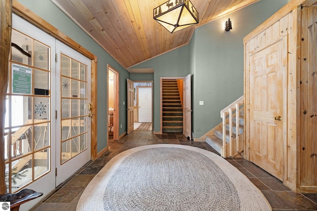 foyer featuring lofted ceiling, plenty of natural light, and wood ceiling