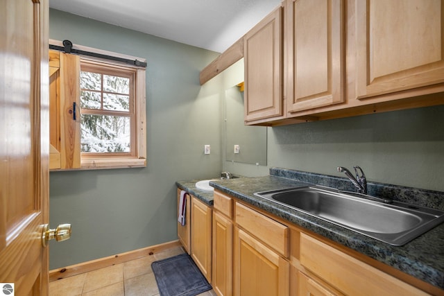 kitchen with sink, light tile patterned floors, and light brown cabinets