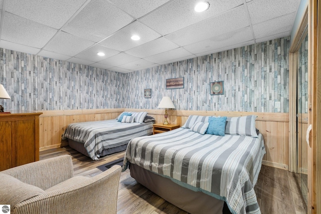 bedroom with hardwood / wood-style flooring and a drop ceiling