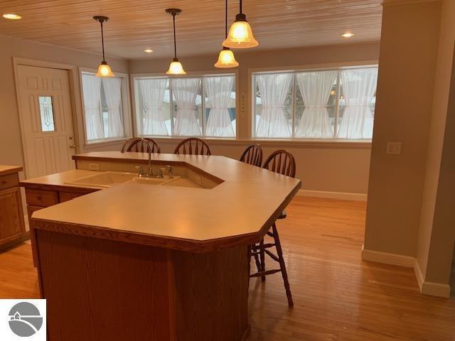 206 N Maple, Bellaire, MI 49615 - kitchen with wood ceiling, light wood-type flooring, decorative light fixtures, light countertops, and recessed lighting