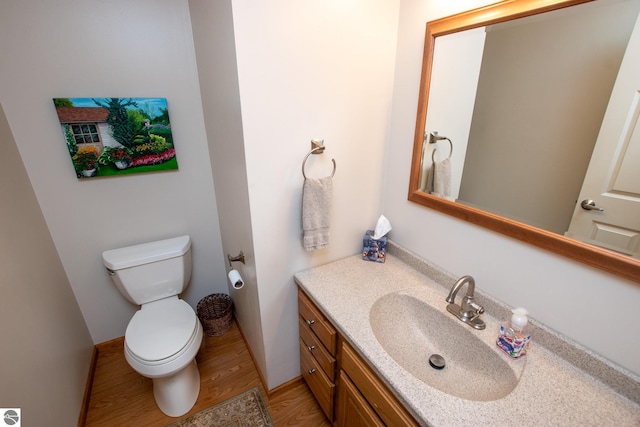 bathroom featuring vanity, hardwood / wood-style floors, and toilet