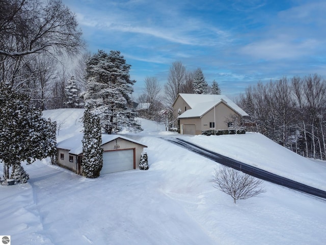 snow covered property featuring a garage