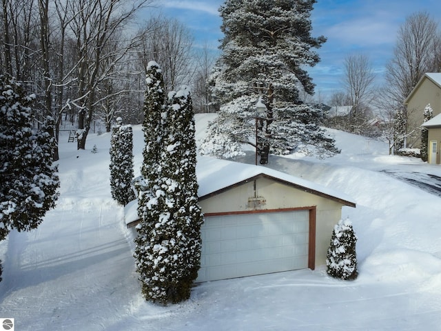 view of snow covered exterior with a garage