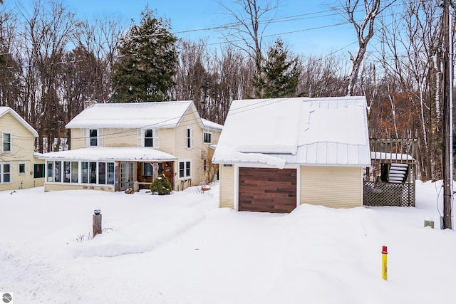 snow covered house with a sunroom