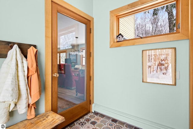 mudroom featuring a notable chandelier and baseboard heating