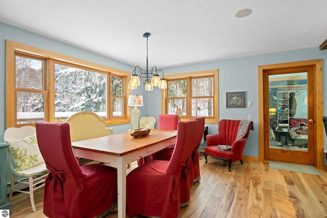 dining space featuring an inviting chandelier, a mountain view, and light wood-type flooring