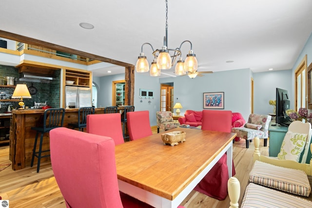 dining room featuring a notable chandelier and light hardwood / wood-style flooring