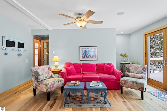 living room featuring ceiling fan and light hardwood / wood-style flooring