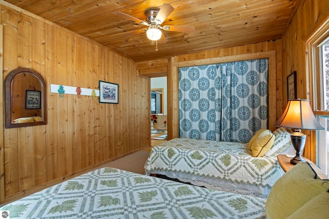 bedroom with wood ceiling, wooden walls, and ceiling fan