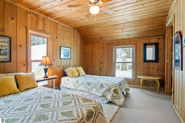 carpeted bedroom featuring wooden walls, vaulted ceiling, and wooden ceiling